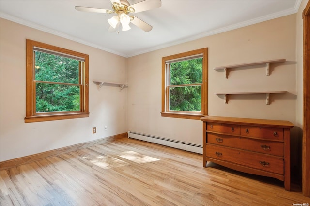 unfurnished bedroom featuring baseboard heating, multiple windows, and light hardwood / wood-style flooring