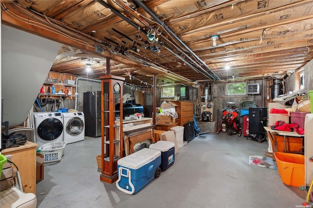 basement featuring separate washer and dryer and stainless steel refrigerator