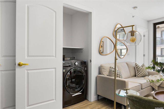 laundry area with light wood-type flooring and washer / clothes dryer