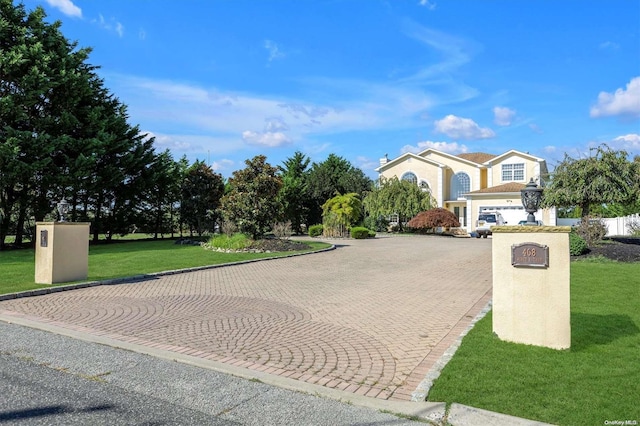 view of front of property with a garage and a front lawn