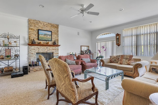 living room with ceiling fan, a fireplace, and ornamental molding