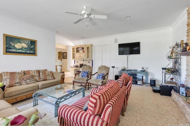 living room with ceiling fan, light carpet, and ornamental molding