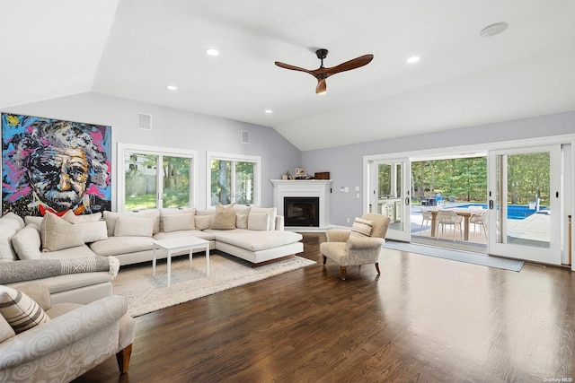 living room with a wealth of natural light, ceiling fan, vaulted ceiling, and hardwood / wood-style flooring