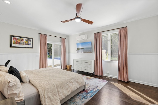 bedroom featuring a wall mounted air conditioner, access to exterior, ceiling fan, crown molding, and dark hardwood / wood-style floors