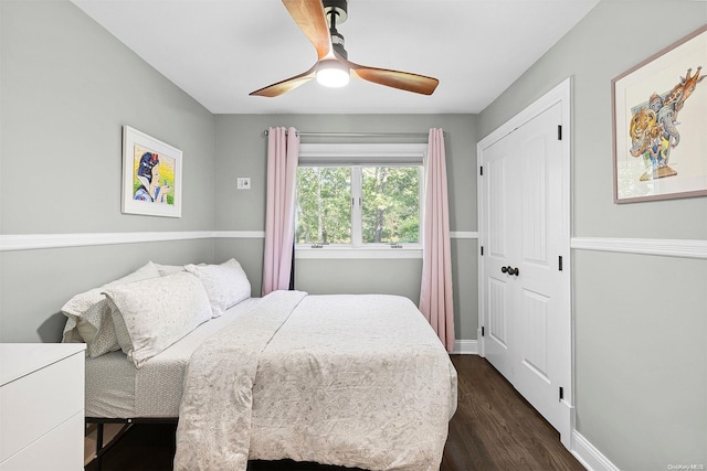 bedroom with ceiling fan, a closet, and dark hardwood / wood-style floors