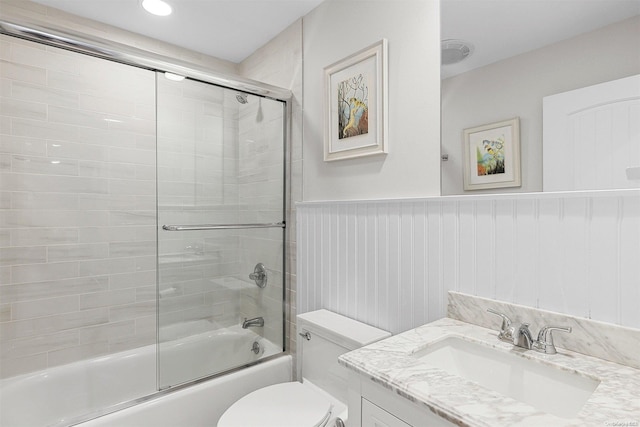 full bathroom featuring vanity, toilet, and enclosed tub / shower combo