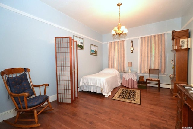 bedroom with dark hardwood / wood-style floors, baseboard heating, and a chandelier