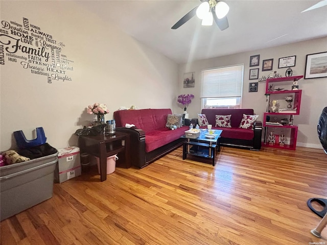 living room featuring ceiling fan and hardwood / wood-style flooring