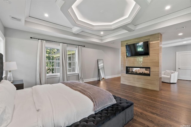 bedroom featuring a multi sided fireplace and dark hardwood / wood-style flooring