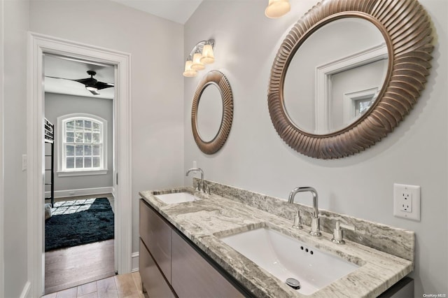 bathroom with ceiling fan, vanity, and hardwood / wood-style flooring