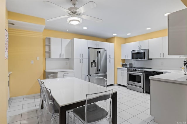 215 Middle Neck Rd Unit 16-1A, Great Neck, NY 11021 - kitchen with light tile patterned flooring, ceiling fan, white cabinets, and stainless steel appliances