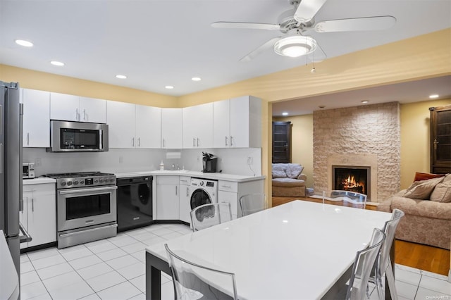 215 Middle Neck Rd Unit 16-1A, Great Neck, NY 11021 - kitchen featuring washer / clothes dryer, white cabinetry, and stainless steel appliances