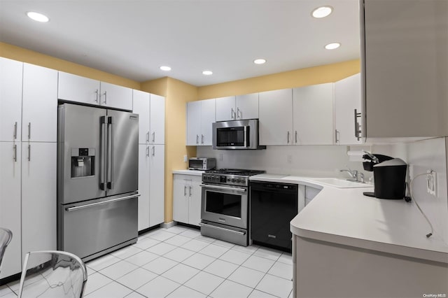 215 Middle Neck Rd Unit 16-1A, Great Neck, NY 11021 - kitchen featuring stainless steel appliances, a sink, light countertops, recessed lighting, and light tile patterned floors