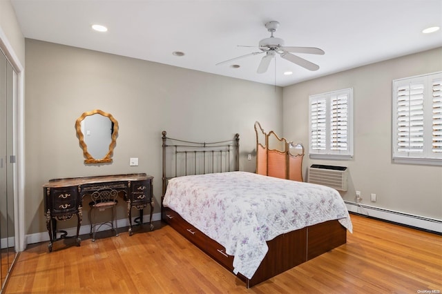 215 Middle Neck Rd Unit 16-1A, Great Neck, NY 11021 - bedroom featuring a baseboard radiator, light wood finished floors, an AC wall unit, recessed lighting, and ceiling fan