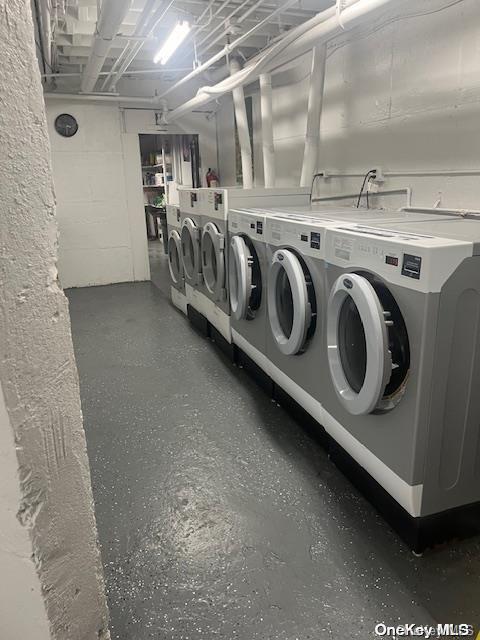 215 Middle Neck Rd Unit 16-1A, Great Neck, NY 11021 - shared laundry room with independent washer and dryer