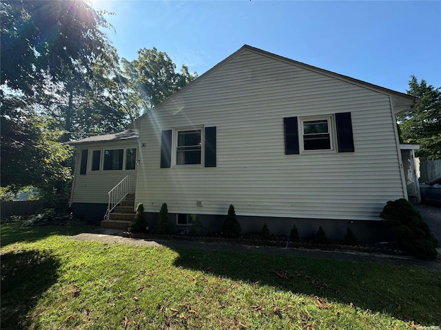 rear view of house featuring a yard