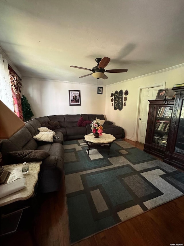 living room featuring ceiling fan, dark hardwood / wood-style flooring, and ornamental molding