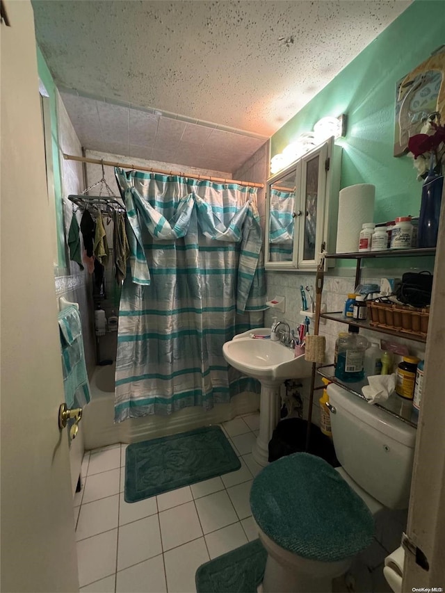 bathroom featuring tile patterned flooring, shower / bath combo, and toilet