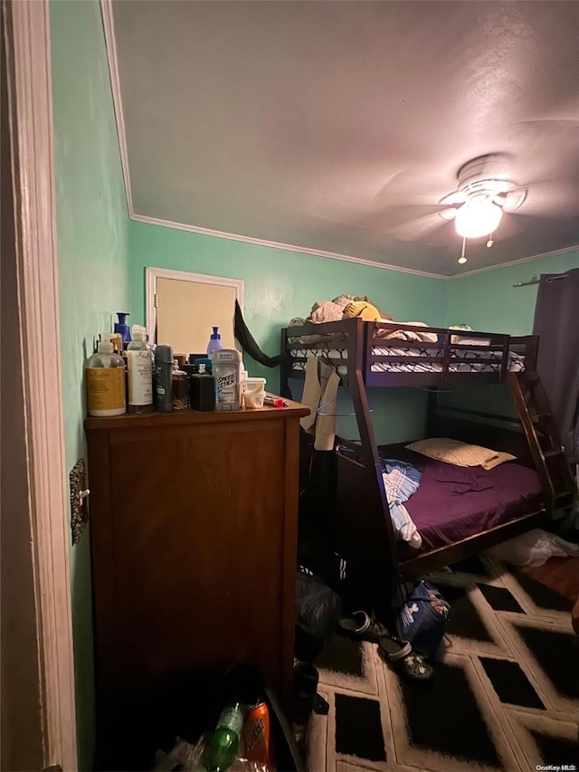 bedroom with ceiling fan and ornamental molding