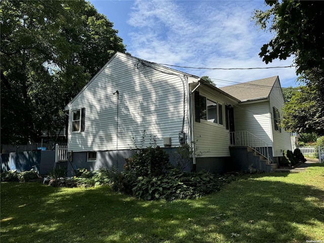 view of property exterior with a yard