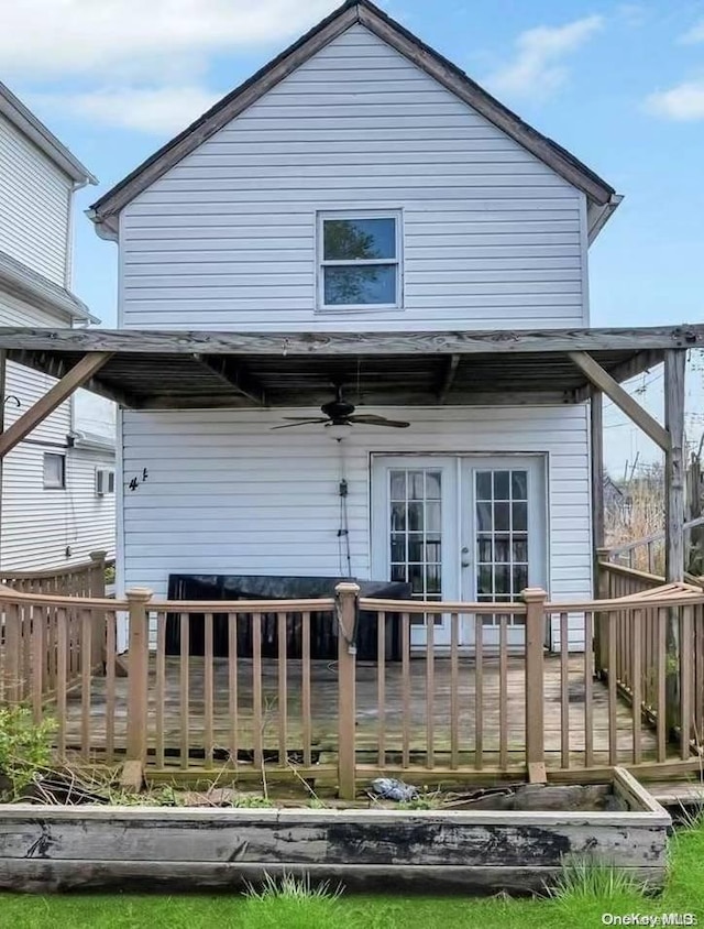 rear view of property with ceiling fan, french doors, and a deck