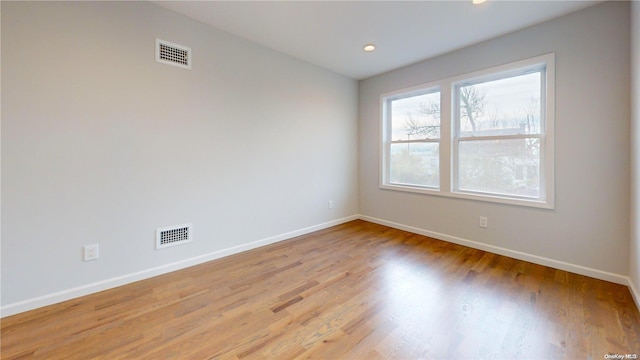 unfurnished room with light wood-type flooring