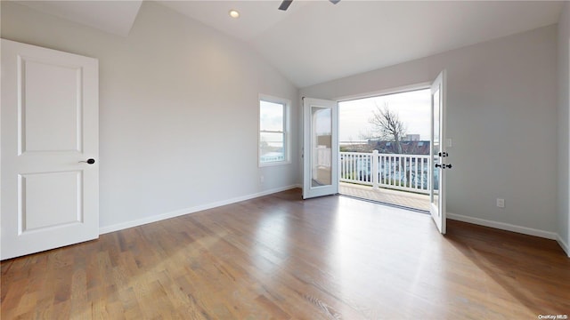 spare room with lofted ceiling and hardwood / wood-style floors