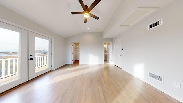 interior space with ceiling fan, plenty of natural light, lofted ceiling, and french doors