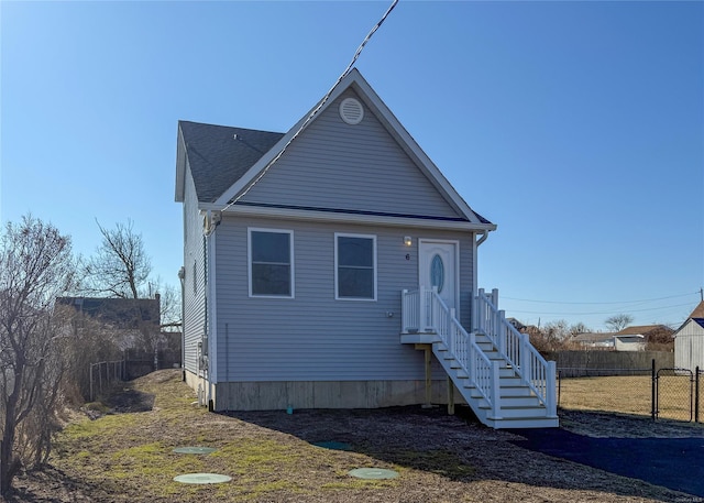 view of front of home featuring fence