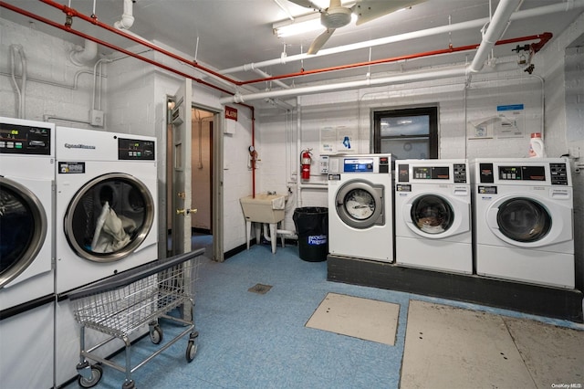 laundry area with washer and clothes dryer and sink