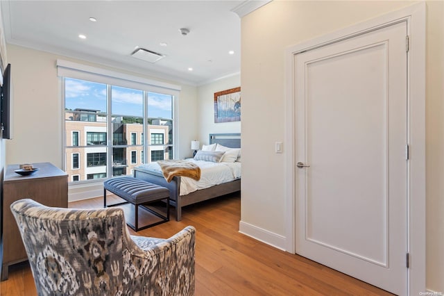 bedroom featuring light hardwood / wood-style flooring and ornamental molding