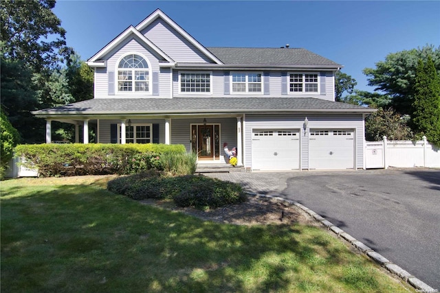 view of front of home featuring a front yard and a garage