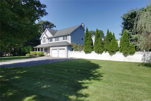 view of front of home with a front yard and a garage