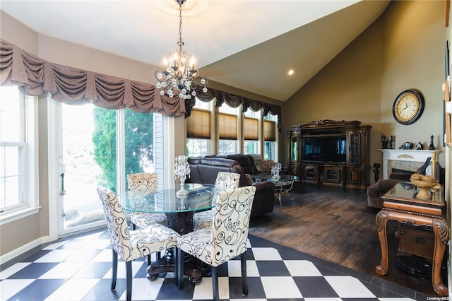 dining space featuring wood-type flooring, plenty of natural light, and lofted ceiling