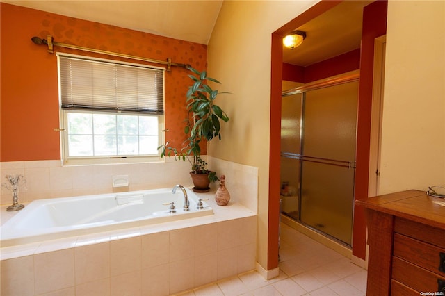 bathroom with tile patterned floors, vaulted ceiling, and separate shower and tub