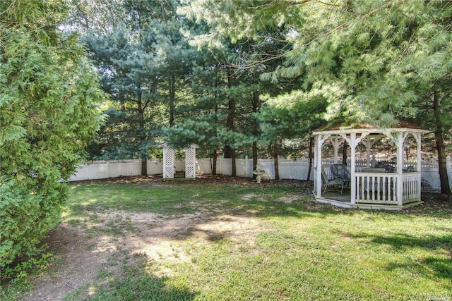 view of yard with a gazebo and a wooden deck