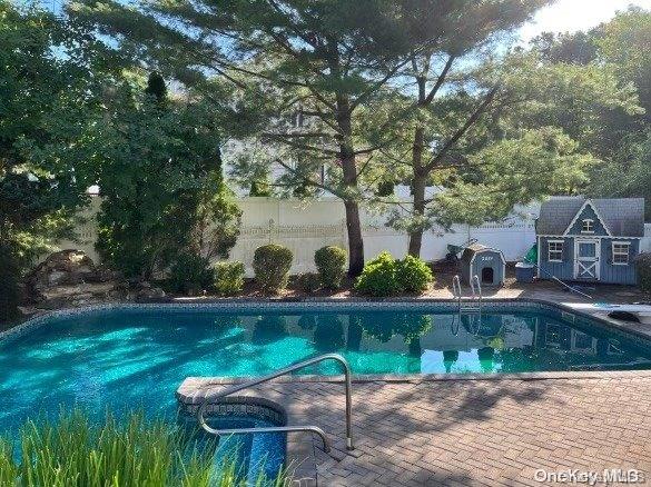 view of pool with a patio area and an outdoor structure