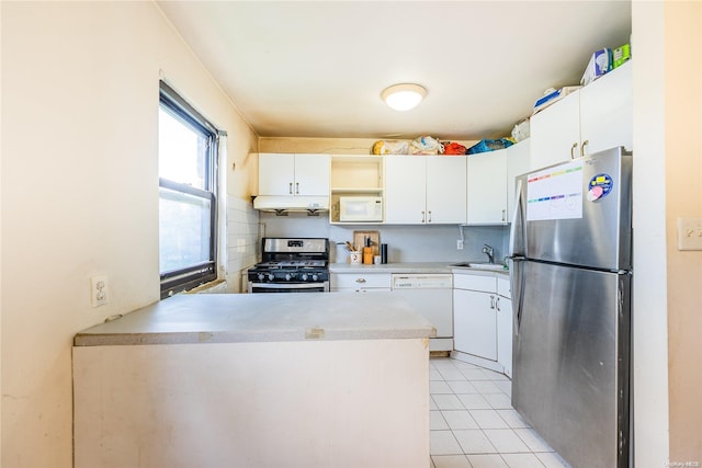 kitchen featuring light tile patterned floors, white cabinetry, sink, and appliances with stainless steel finishes