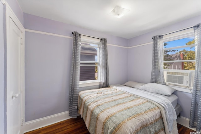 bedroom featuring cooling unit and dark wood-type flooring