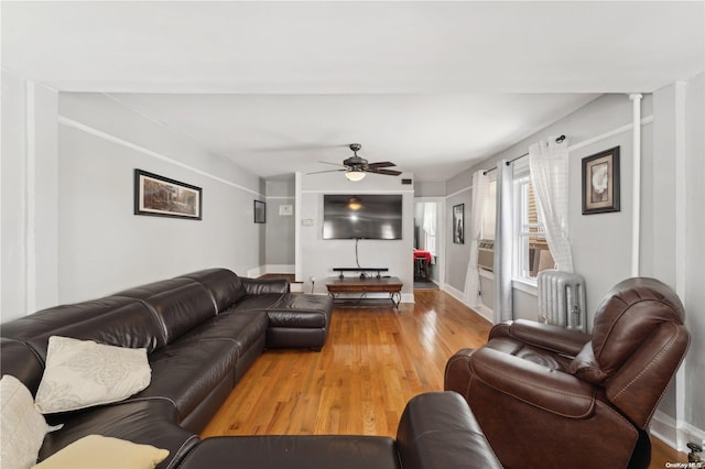 living room with ornate columns, ceiling fan, radiator heating unit, and hardwood / wood-style floors