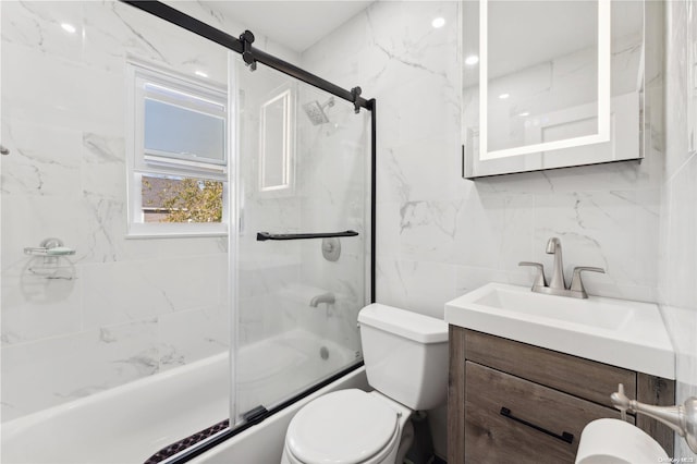 full bathroom featuring combined bath / shower with glass door, toilet, decorative backsplash, vanity, and tile walls