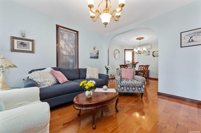 living room with wood-type flooring and a notable chandelier