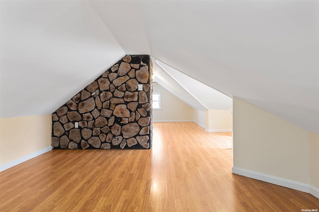 bonus room featuring light hardwood / wood-style flooring and vaulted ceiling