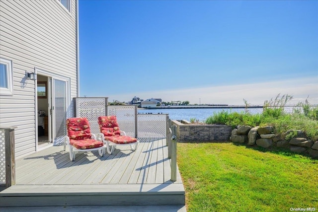 wooden terrace with a yard and a water view