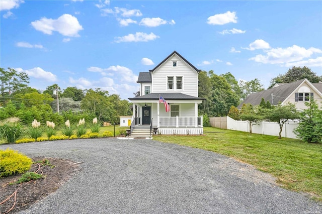 view of front facade featuring a front lawn and covered porch