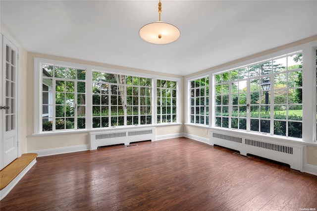 unfurnished sunroom featuring radiator heating unit