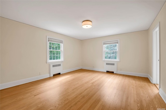 spare room with light hardwood / wood-style flooring and radiator