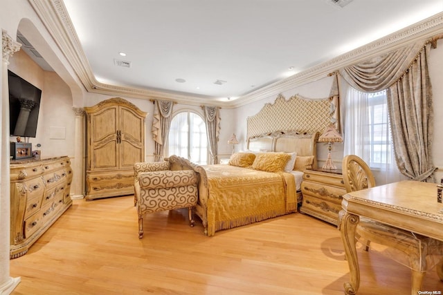 bedroom with light hardwood / wood-style floors and crown molding