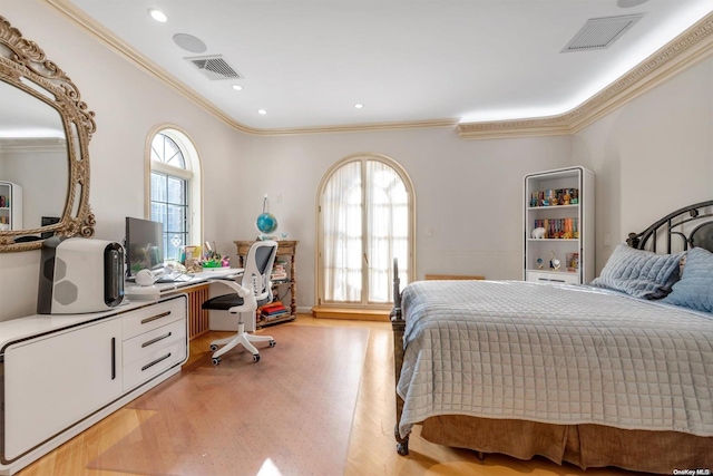 bedroom featuring ornamental molding, light hardwood / wood-style flooring, and multiple windows