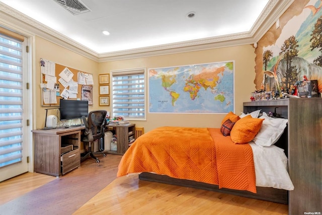 bedroom with light wood-type flooring, ornamental molding, and multiple windows